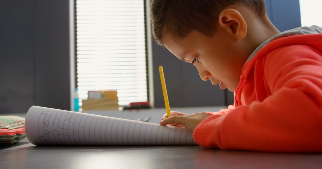 Attentive Child Writing in Classroom with Focus on Learning