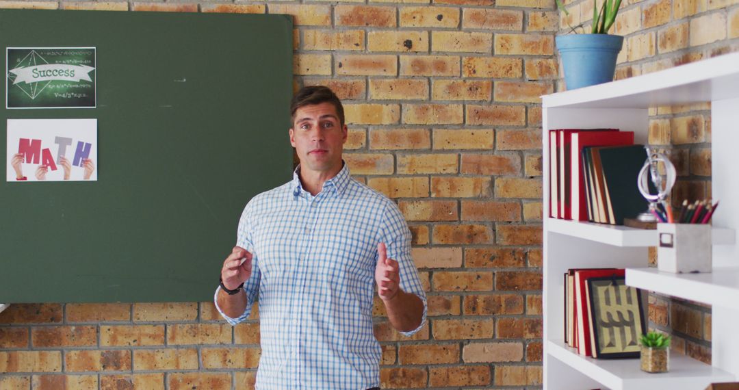 Caucasian male teacher standing at blackboard giving an online lesson to camera - Free Images, Stock Photos and Pictures on Pikwizard.com