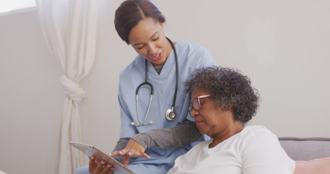 Healthcare Worker Assisting Senior Woman with Tablet - Free Images, Stock Photos and Pictures on Pikwizard.com