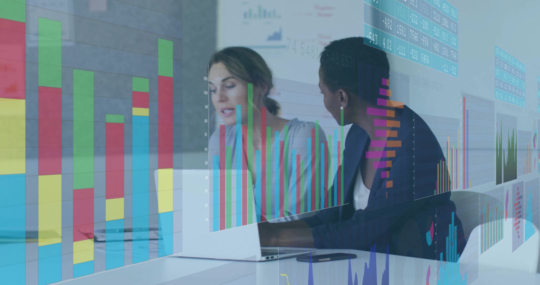 Businesswomen Analyzing Data on Laptop with Graph Overlays