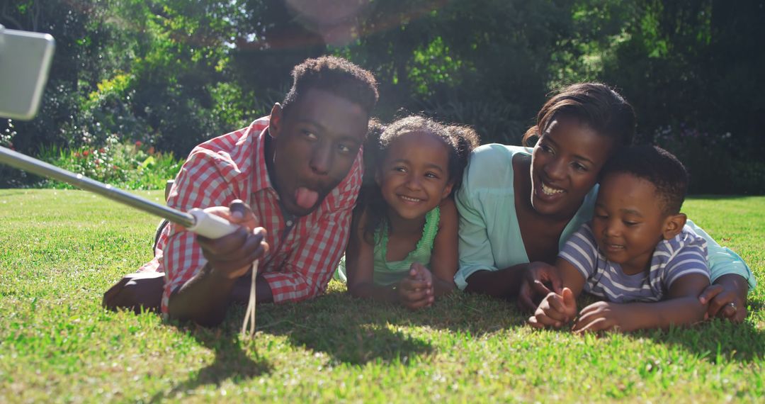 Family Taking Selfie in Sunny Park Lying on Grass - Free Images, Stock Photos and Pictures on Pikwizard.com