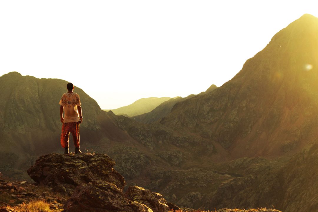 Hiking Adventure: Man Standing On Cliff At Sunset With Mountain Background - Free Images, Stock Photos and Pictures on Pikwizard.com