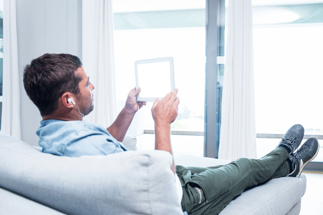 Man Relaxing at Home with Transparent Tablet Mockup