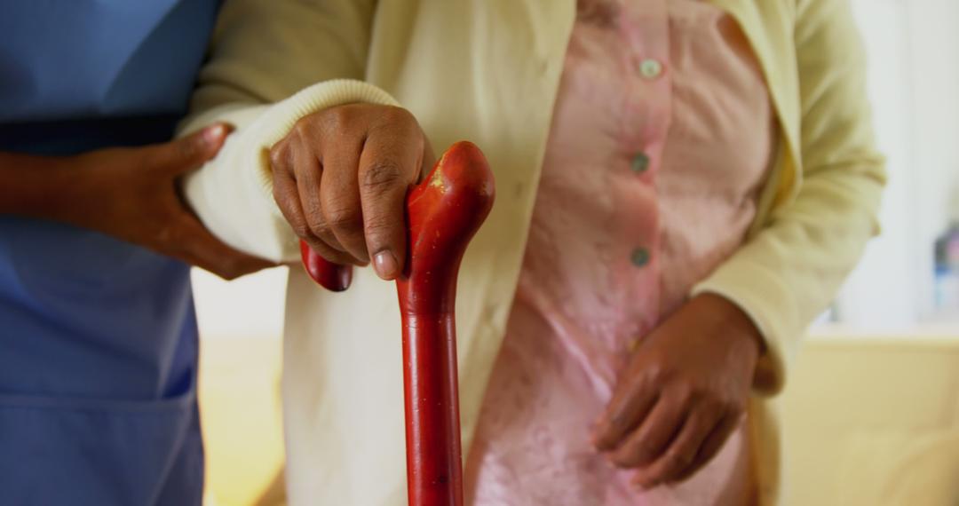 Senior Individual Using Red Cane Assisted by Caregiver - Free Images, Stock Photos and Pictures on Pikwizard.com