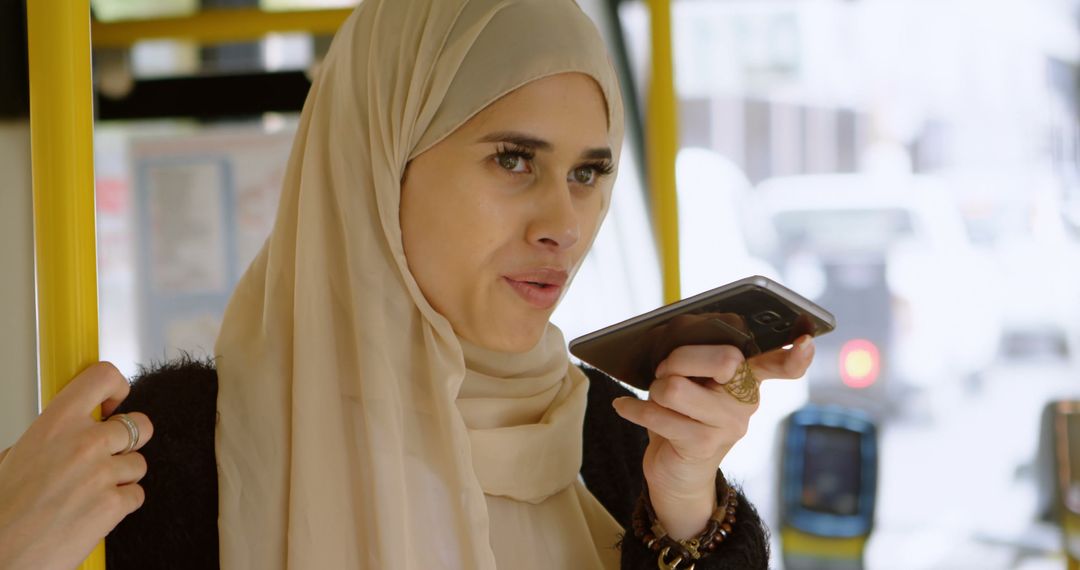 Muslim Woman Wearing Hijab Using Smartphone in Public Transit - Free Images, Stock Photos and Pictures on Pikwizard.com