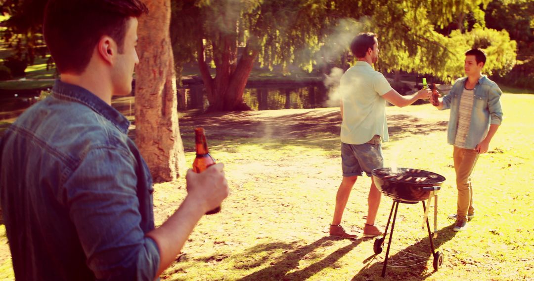 Group of Young Men Enjoying a Barbecue in Park - Free Images, Stock Photos and Pictures on Pikwizard.com