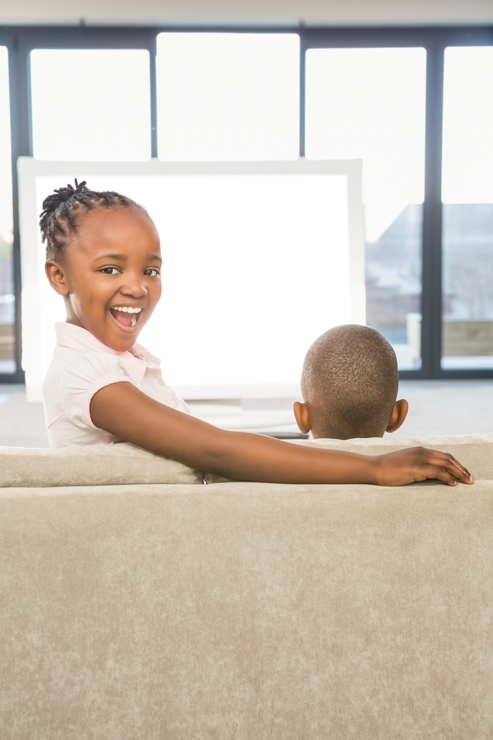 Cheerful African American Children Sitting on Sofa in Front of Transparent Screen - Download Free Stock Images Pikwizard.com