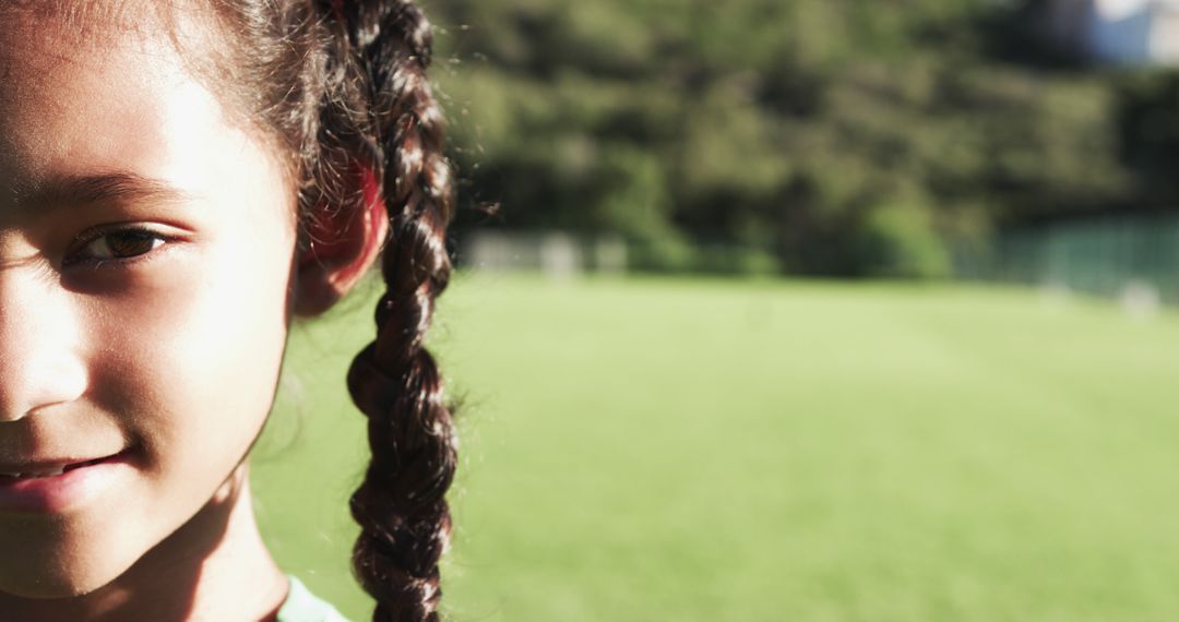 Young Girl with Braided Hair Standing on Sunny Field - Free Images, Stock Photos and Pictures on Pikwizard.com