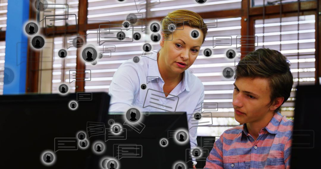 Teacher Guiding Teen at Computer with Floating Chat Icons for Classroom Tech Mentoring
