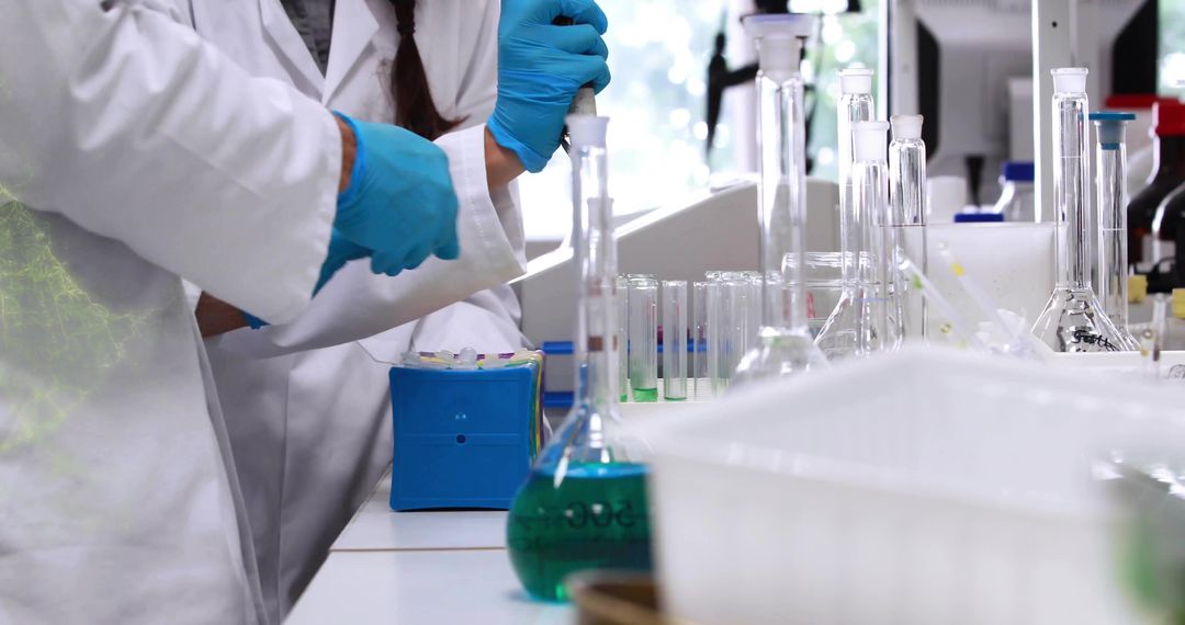 Scientists Using Pipette in Innovative Biotechnology Laboratory