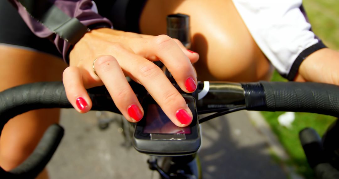 Close-Up of Woman's Hand Using Bike Computer while Cycling Outdoors - Free Images, Stock Photos and Pictures on Pikwizard.com