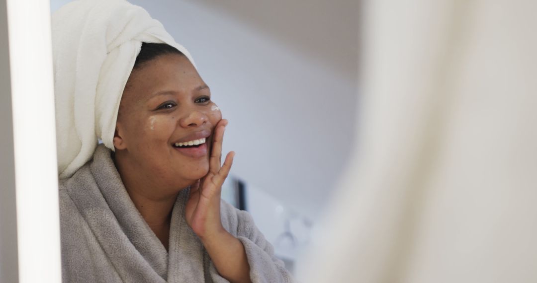 Smiling Woman in Robe Applying Skincare Product - Free Images, Stock Photos and Pictures on Pikwizard.com