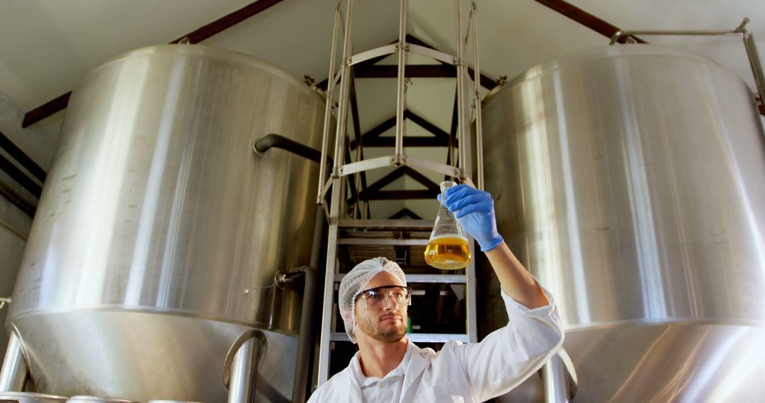 Microbiologist Inspecting Sample in Liquid Tank Facility - Free Images, Stock Photos and Pictures on Pikwizard.com