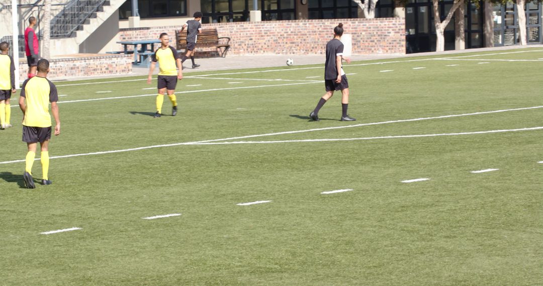 Soccer Players Practicing and Dribbling on Field During Sunny Day
