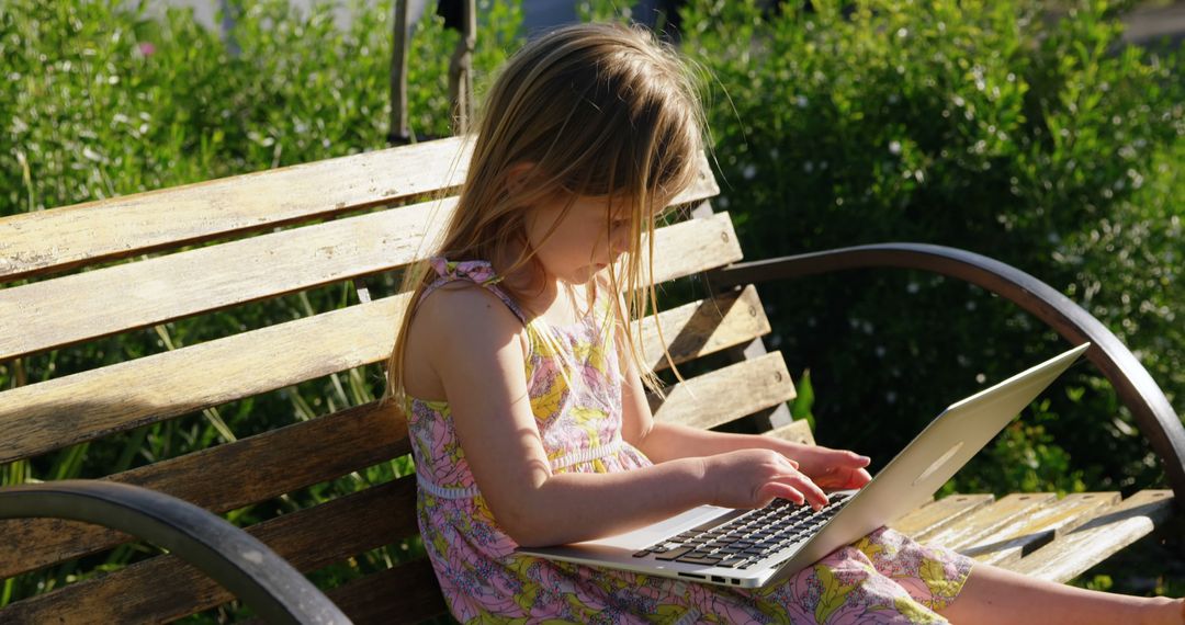 Young Girl Using Laptop on Park Bench in Summer - Free Images, Stock Photos and Pictures on Pikwizard.com