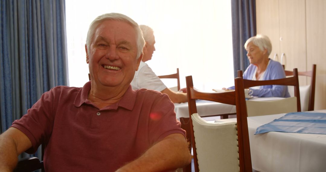 Happy Senior Man Smiling in Retirement Home Dining Area - Free Images, Stock Photos and Pictures on Pikwizard.com