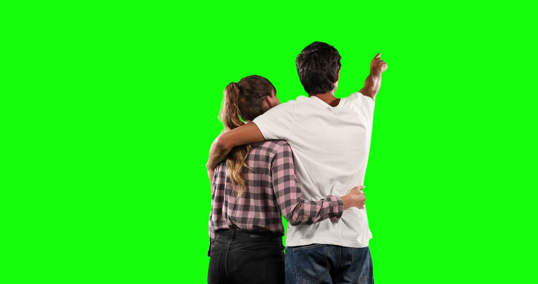 Couple Embracing and Pointing at Green Screen Background