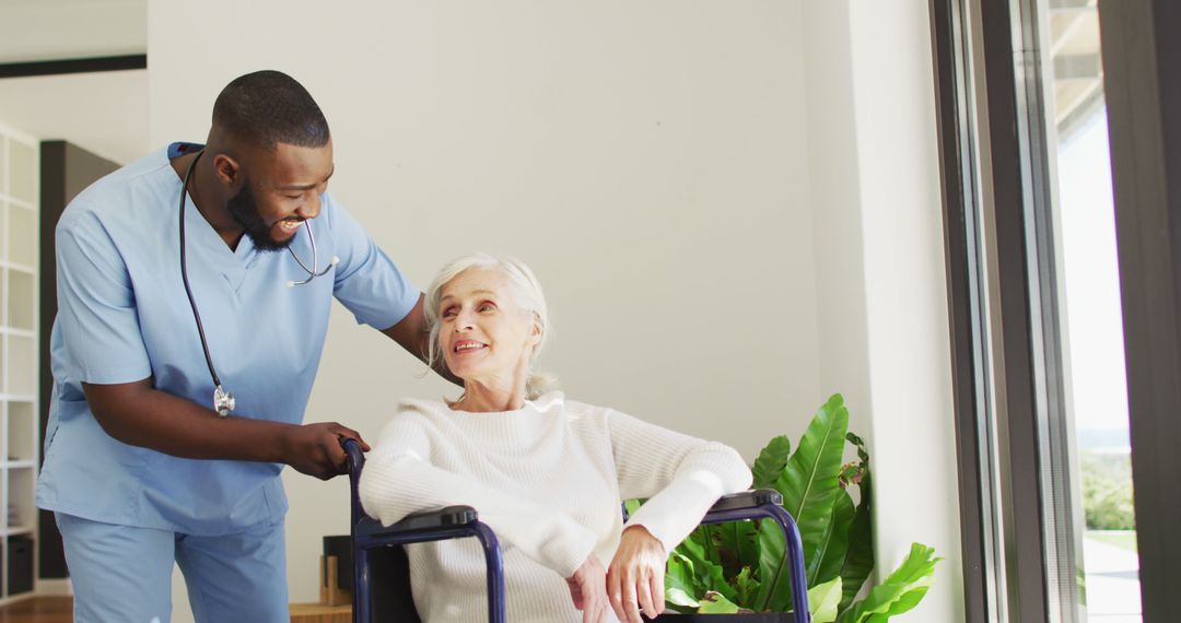 Image of happy african american male doctor taking care of caucasian senior woman - Free Images, Stock Photos and Pictures on Pikwizard.com