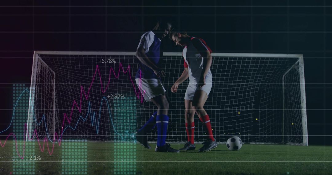 Two soccer players facing off in front of goal at night with performance analytics overlay