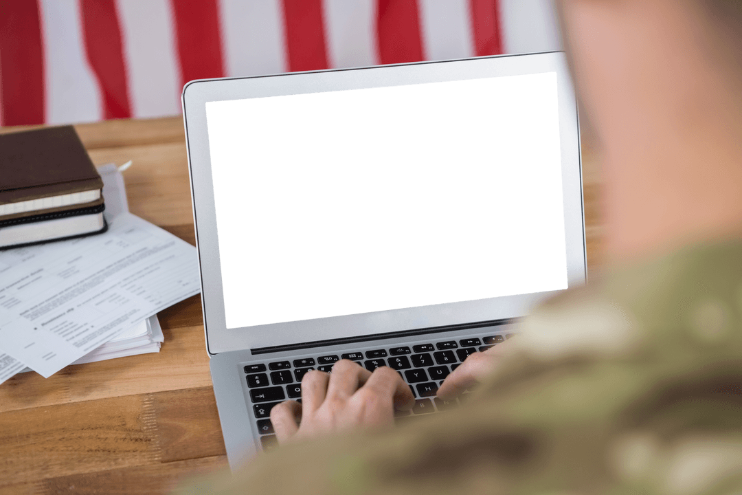 Soldier Working on Transparent Laptop with US Flag in Background