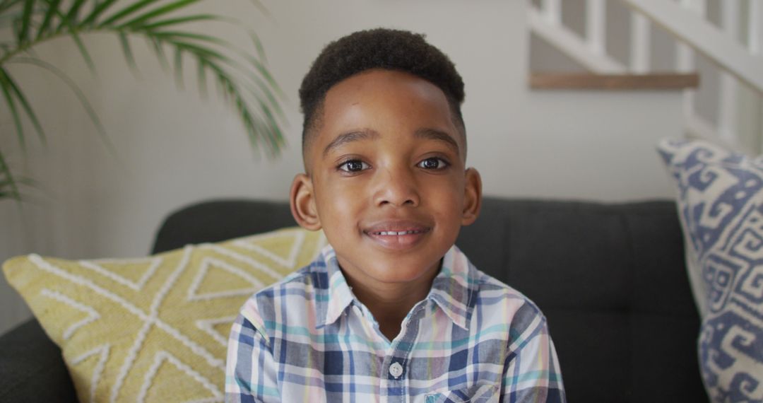 Smiling African American Boy Sitting in Living Room - Free Images, Stock Photos and Pictures on Pikwizard.com