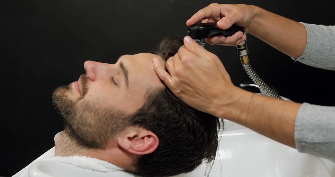 Man Relaxing While Getting Hair Washed at Salon - Free Images, Stock Photos and Pictures on Pikwizard.com