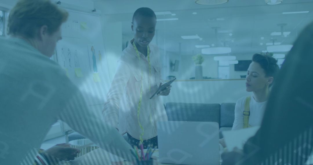 Fashion Designer Showcasing Digital Designs in Collaborative Studio