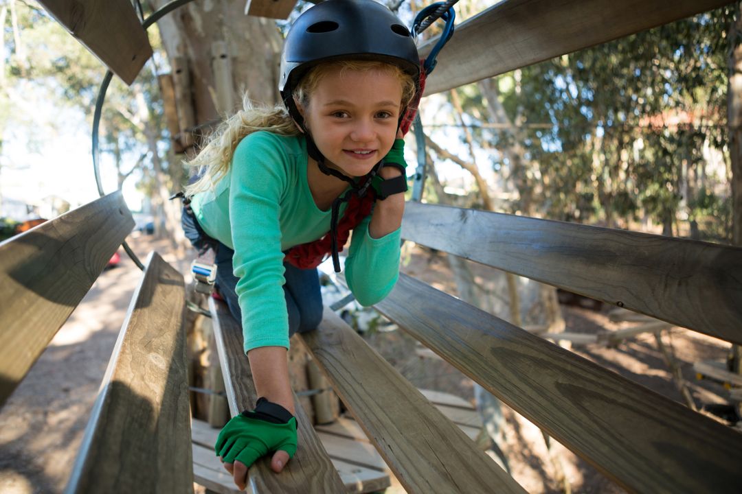 Little girl wearing helmet trying to cross obstacle - Free Images, Stock Photos and Pictures on Pikwizard.com