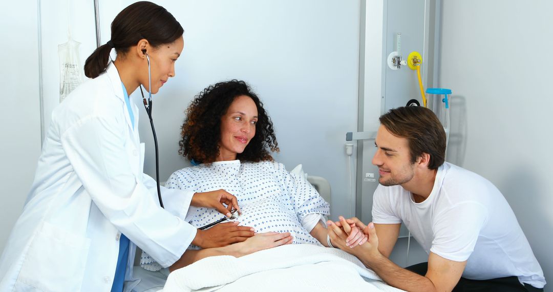 Doctor Examining Pregnant Woman in Hospital Bed with Supportive Partner - Free Images, Stock Photos and Pictures on Pikwizard.com