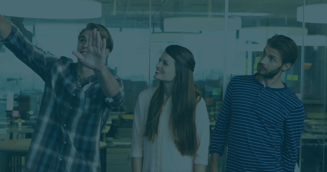 Team Collaborating Behind Office Glass Partition