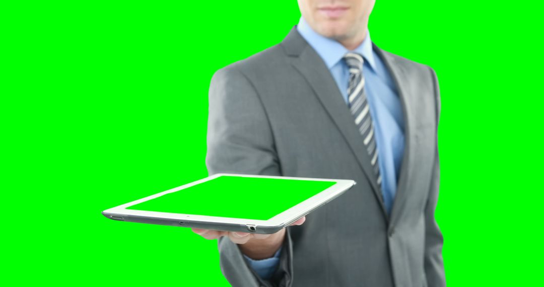 Businessman Presenting Tablet with Green Screen - Free Images, Stock Photos and Pictures on Pikwizard.com