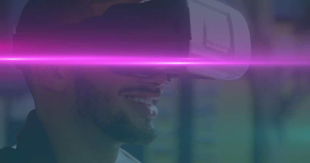 Image of blue and pink light trails moving over biracial man wearing vr headset - Free Images, Stock Photos and Pictures on Pikwizard.com