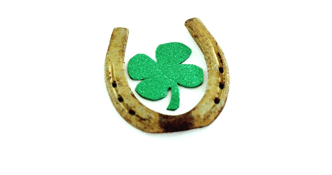 A rusty horseshoe and a glittery clover merge as symbols of luck on a white backdrop. - Free Images, Stock Photos and Pictures on Pikwizard.com