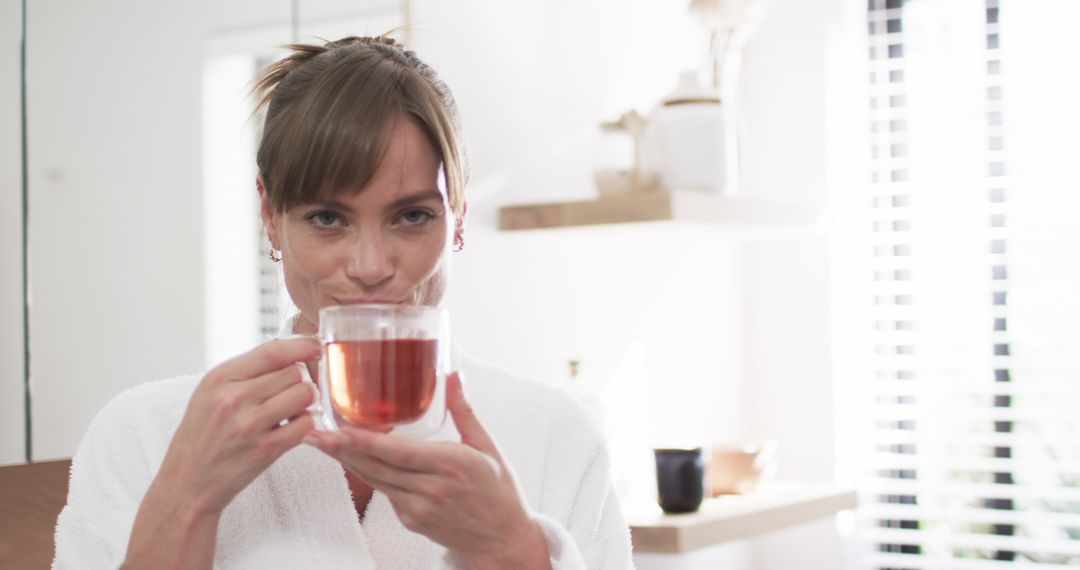 Middle-Aged Woman Relaxing with a Warm Cup of Tea at Home