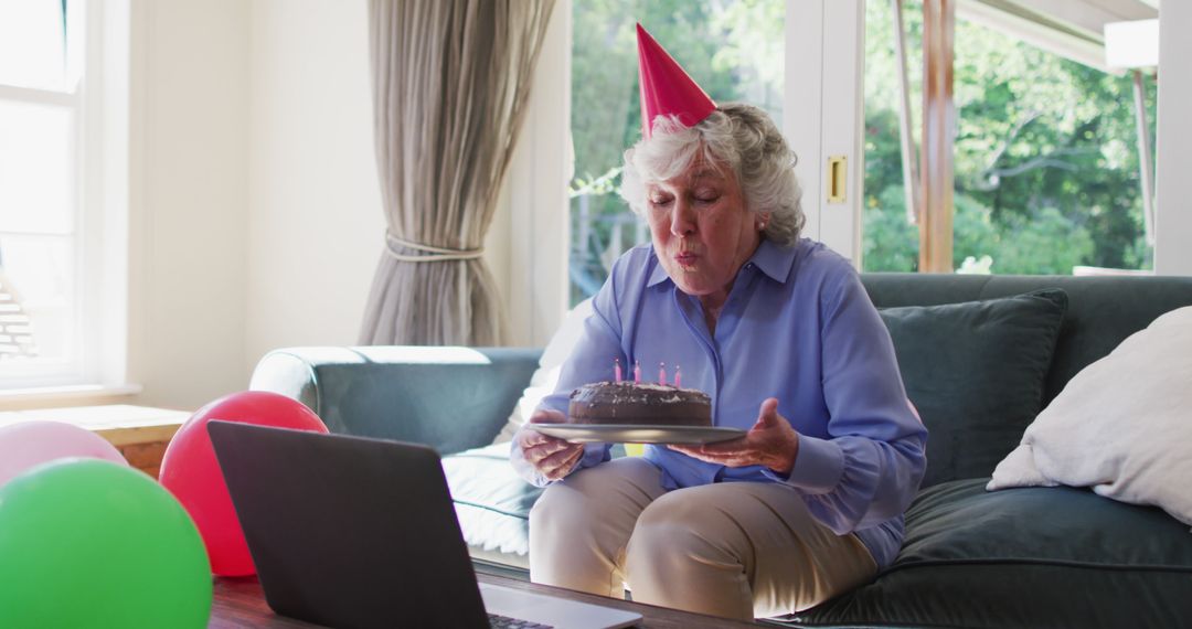 Senior woman celebrates birthday virtually at home amid COVID-19 lockdown. - Free Images, Stock Photos and Pictures on Pikwizard.com