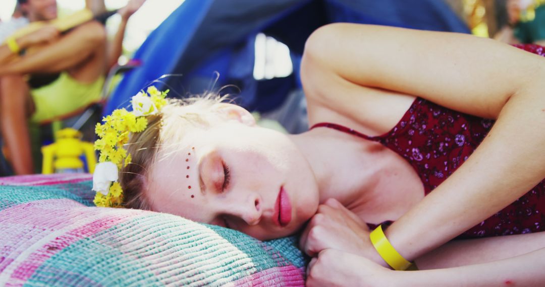 Young Woman Relaxing at Festival with Floral Headband - Free Images, Stock Photos and Pictures on Pikwizard.com