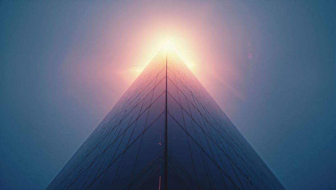 Futuristic Skyscraper with Glowing Apex Light and Lens Flare