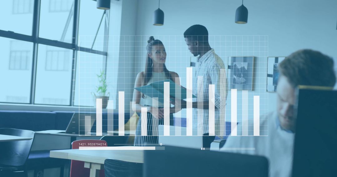 Coworkers Discussing Data Analysis in Modern Office Environment