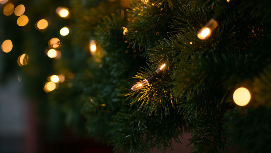 Glowing Warm White String Lights on Dense Evergreen Garland with Soft Bokeh Glow