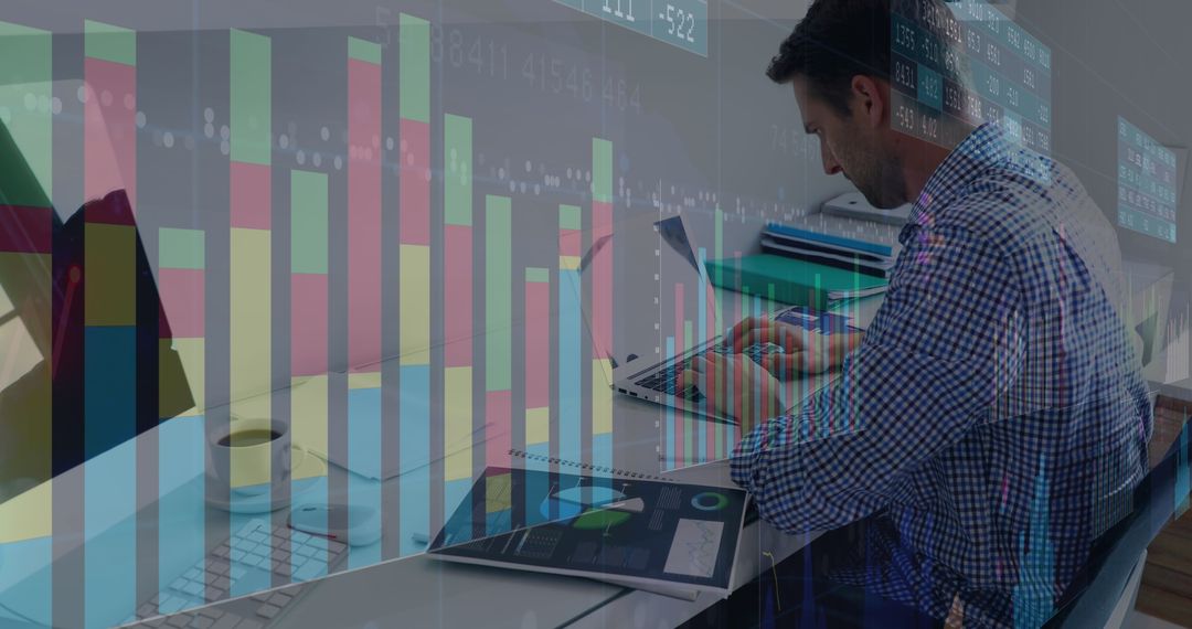Focused Businessman Analyzing Financial Data with Charts and Tech