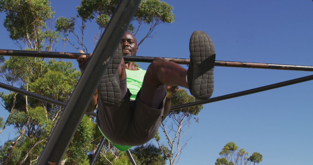 Active Man Exercising on Jungle Gym on a Sunny Day - Free Images, Stock Photos and Pictures on Pikwizard.com