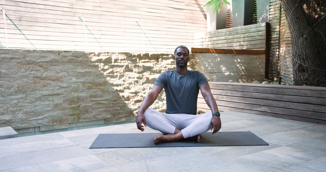 Man Practicing Meditation Outdoors in Serene Backyard Setting