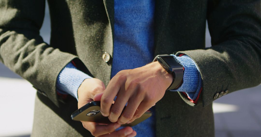 Close-up of person using smartphone and wearing smartwatch in outdoor - Free Images, Stock Photos and Pictures on Pikwizard.com