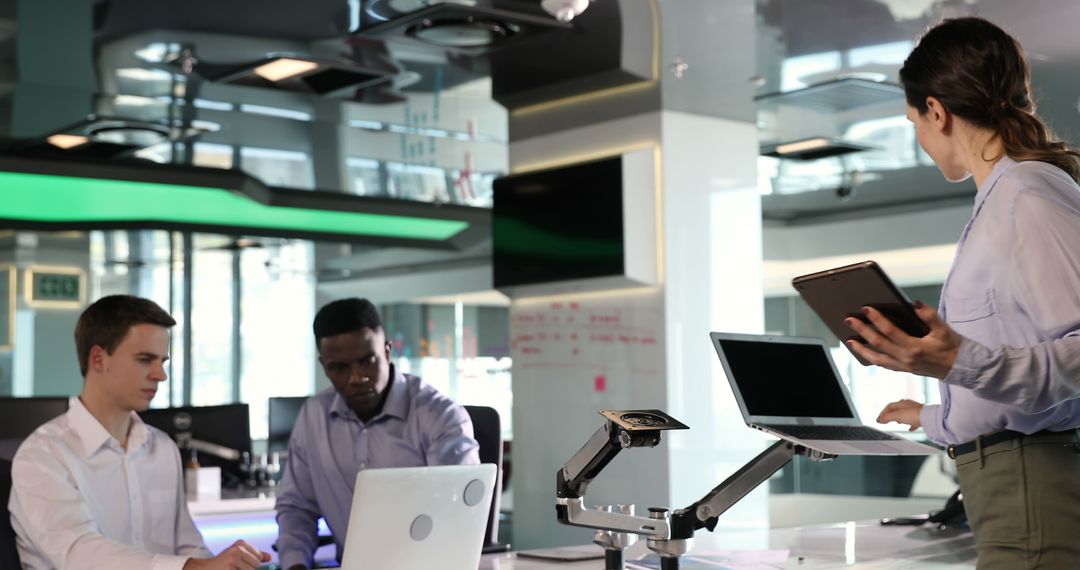 Diverse Professionals Collaborating in Modern High-Tech Office