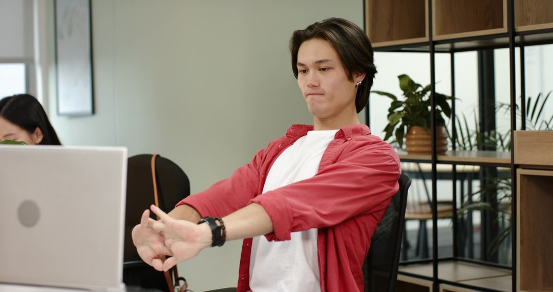 Office Worker Stretching at Desk for Ergonomic Break