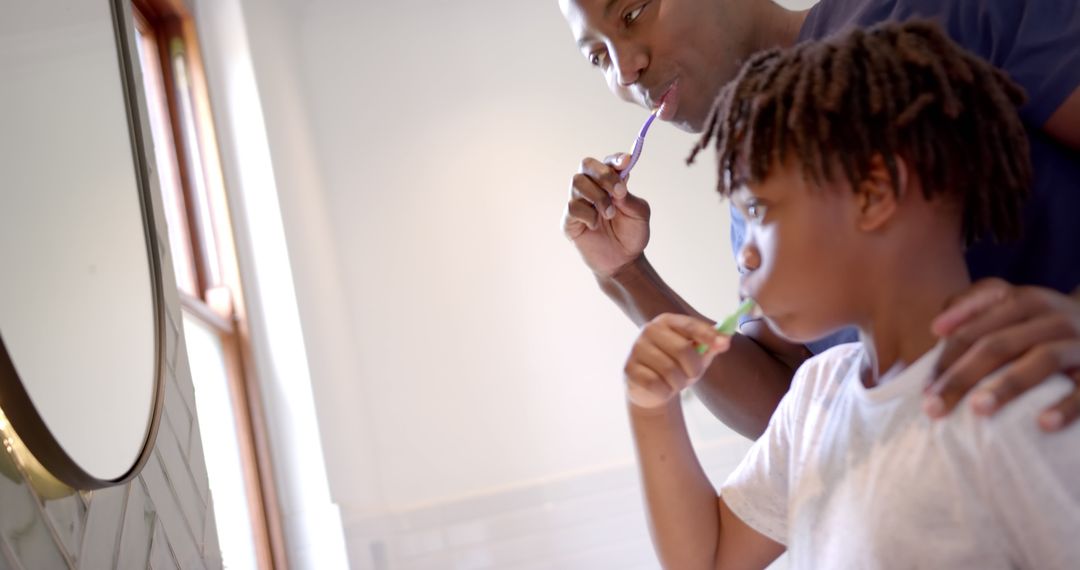 Father and Son Brushing Teeth Together in Morning Routine