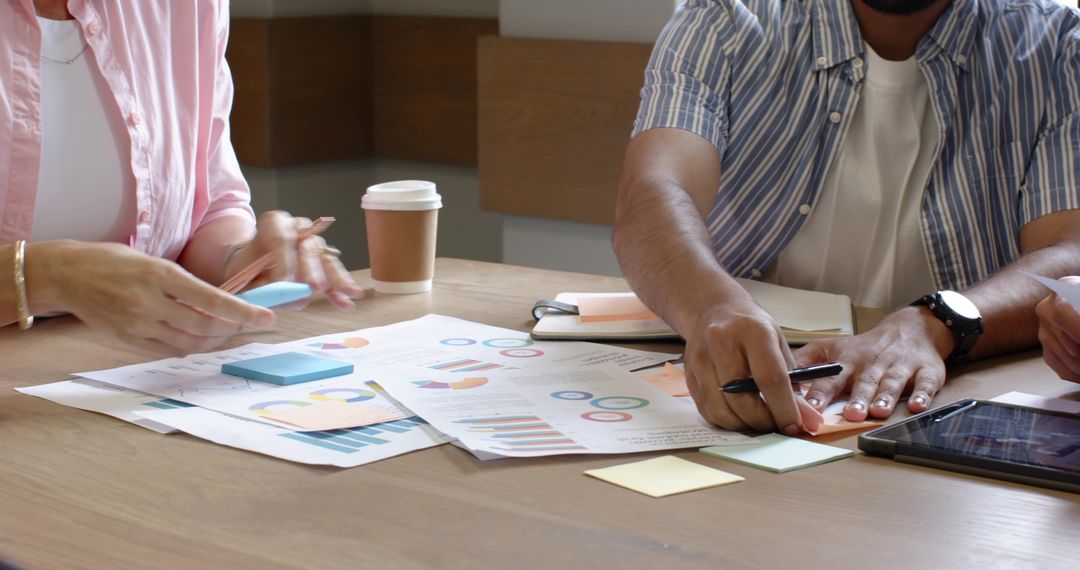 Coworkers Collaborating on Business Strategy with Charts