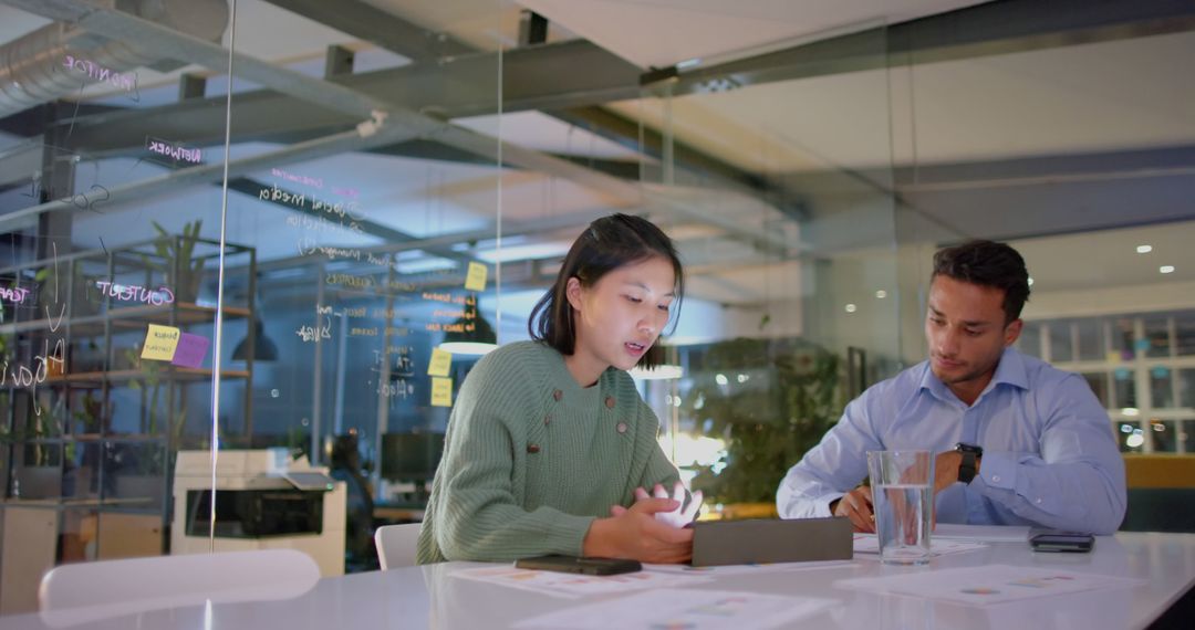 Diverse Team Engaging in Evening Office Discussion