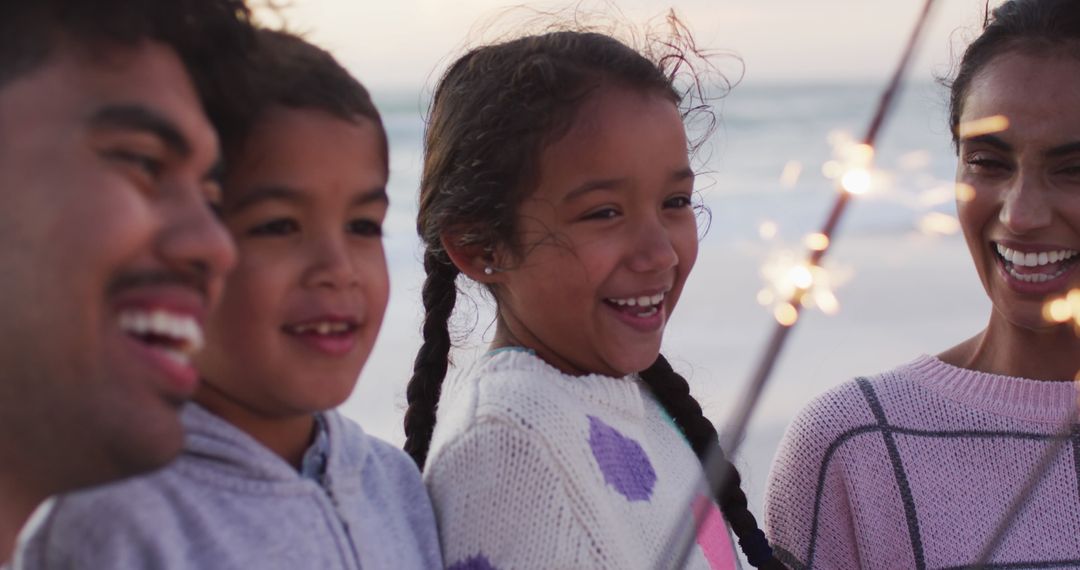Joyful Family with Sparklers on Beach at Sunset