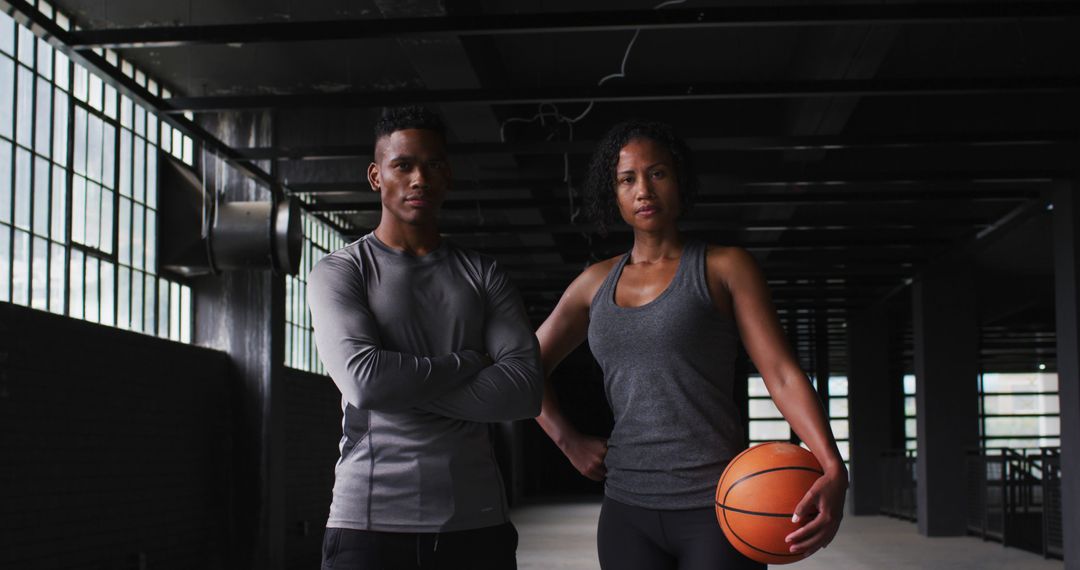 Confident Athletes Posing Indoors with Basketball - Free Images, Stock Photos and Pictures on Pikwizard.com